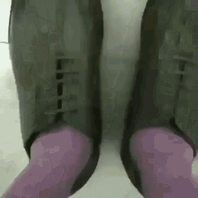 a person is wearing purple socks and black shoes