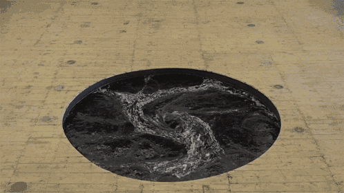 a circular hole in a brick floor with water coming out of it