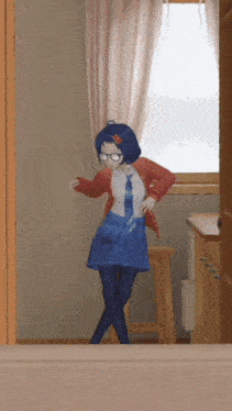 a girl in a red jacket and blue skirt is dancing