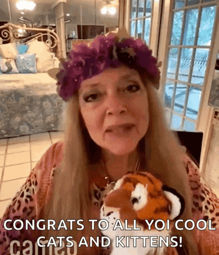 a woman wearing a purple flower crown is holding a stuffed tiger and says congrats to all you cool cats