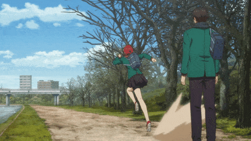 a boy and a girl are walking down a path