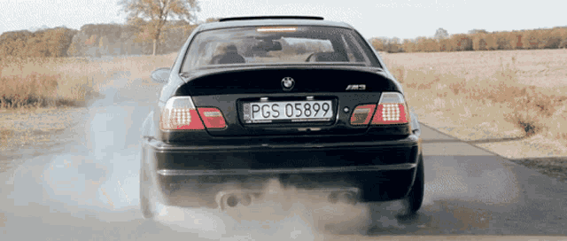 a black bmw with the license plate pgs 05899