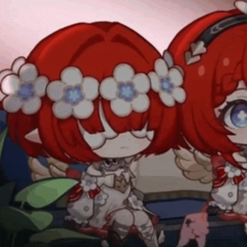 two little girls with red hair and flowers in their hair are sitting next to each other