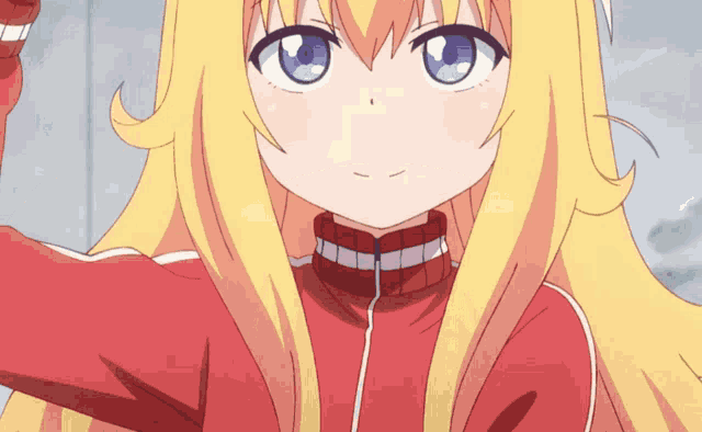 a girl with blonde hair and blue eyes is wearing a red sweater