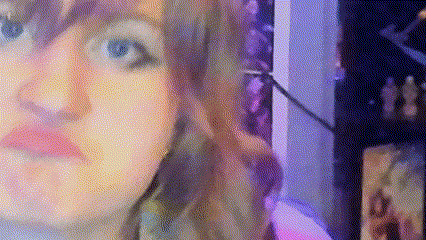 a blurry picture of a woman 's face with a purple background
