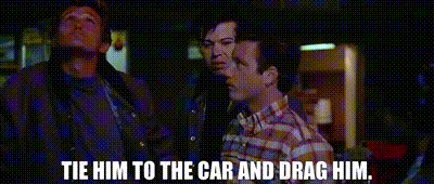 a group of men are standing next to each other and one of them is saying `` tie him to the car and drag him '' .