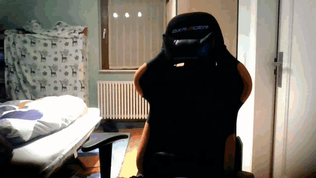 a black and orange chair with the word dxracer on it