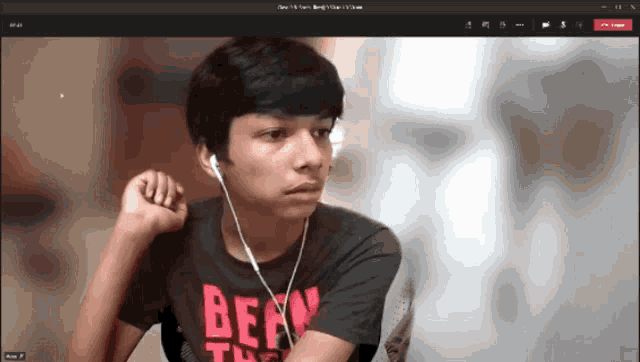 a boy wearing ear buds and a shirt that says bear