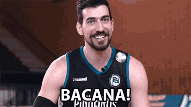 a basketball player wearing a hummel jersey is smiling