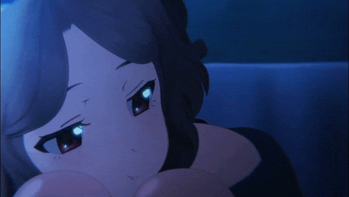 a close up of a girl 's face with red eyes