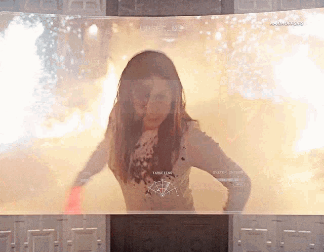 a woman is standing in front of a screen that says targeting on it