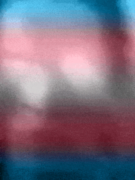 a red white and blue background with a blurred texture