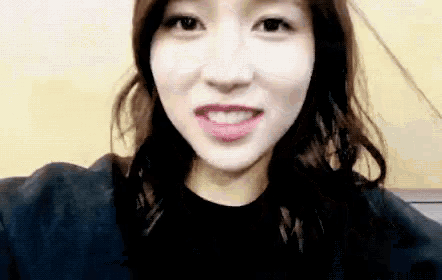 a close up of a woman taking a selfie with her mouth open