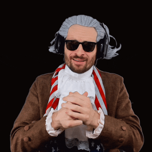 a man wearing a wig and sunglasses has his hands folded in front of him