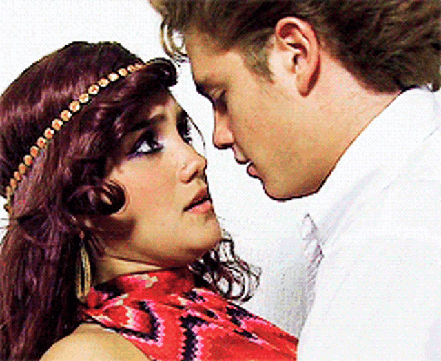 a man and a woman are touching their foreheads