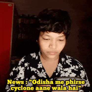 a person looking at a cell phone with the words " odisha me phirse cyclone aane wala hai "