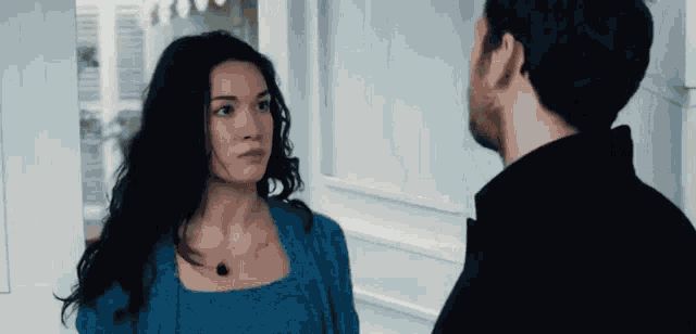 a man and a woman are looking at each other