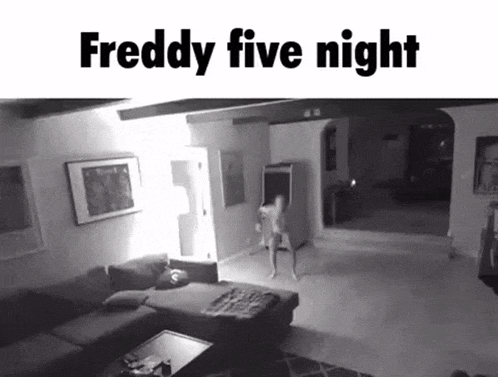 a black and white photo of a living room with a couch and a person standing in it .