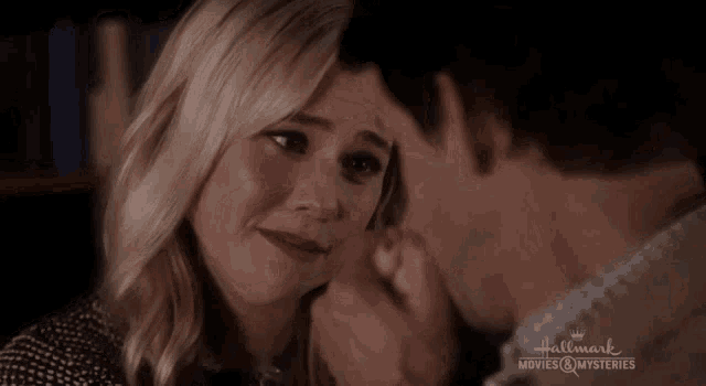 a man kissing a woman 's forehead with the words hallmark movies & mysteries written on the bottom