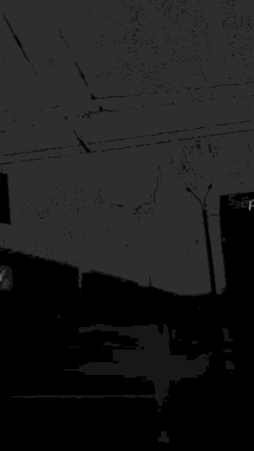 a black and white photo of a lightning bolt over a city street