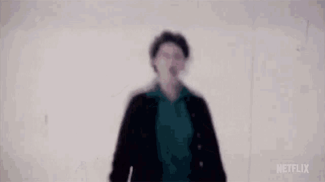 a person is standing in the snow with their arms outstretched and screaming .