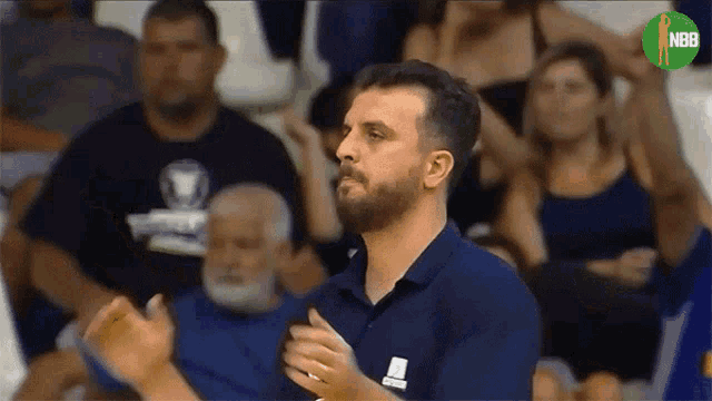 a man in a blue shirt with the word nba on the bottom