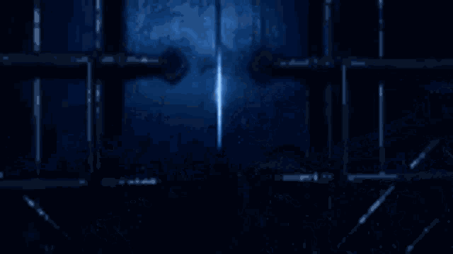 a blurry picture of a person in a dark room with a blue background