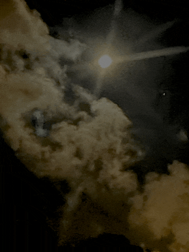 the sun is shining through the clouds in the dark