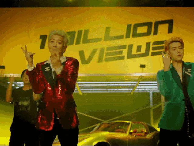 a man in a red jacket stands in front of a yellow sign that says 1 million views