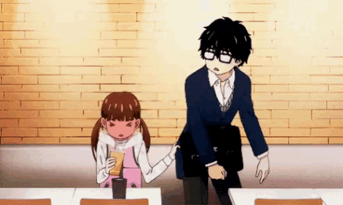 a man and a girl are standing next to each other in a restaurant . the girl is holding the man 's hand .