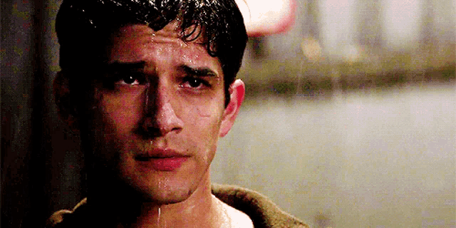 a close up of a man 's face with sweat coming out of his nose .