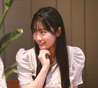 a girl with long black hair is wearing a headband and a white shirt