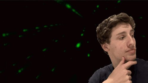 a man 's face is shown with a green light behind him