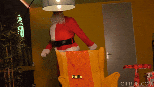 a gif from gifrun.com shows a man dressed as santa claus sitting on a chair