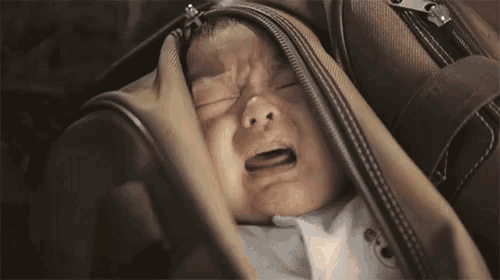 a woman is covering her face with her hand