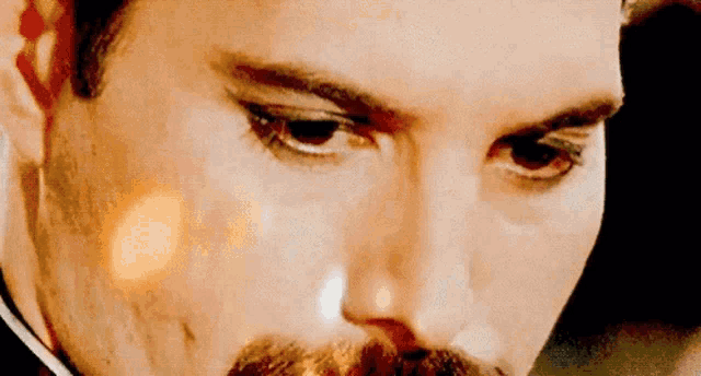a close up of a man 's face with a beard and mustache