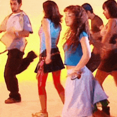 a group of young people are dancing together in a room .