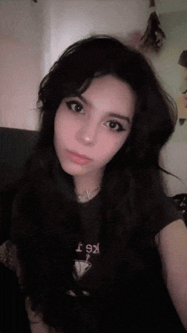 a girl with long black hair is wearing a t-shirt that says kt