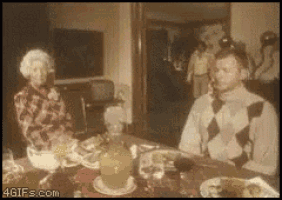a man and woman are sitting at a table with a 4gifs.com logo on the bottom right