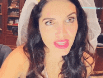 a woman with a veil on her head is making a face