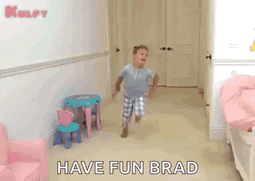 a little boy is running in a room with the words `` have fun brad '' written on the floor .