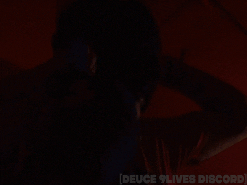 a person in a dark room with the words deuce 9 lives discord on the bottom