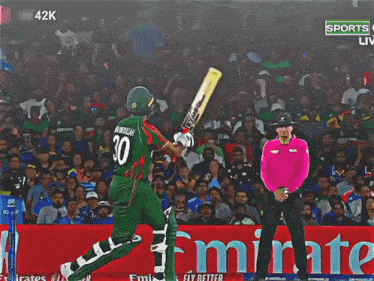 a cricket player wearing the number 30 swings his bat at the ball