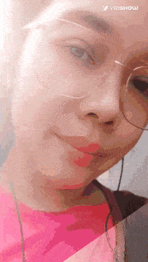 a close up of a woman wearing glasses and earphones