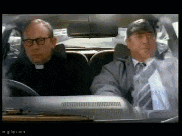 a priest and a man in a suit and tie are driving a car .