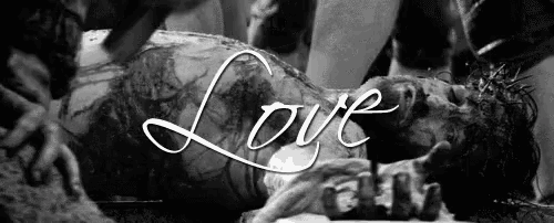 a black and white photo of a man laying on the ground with the word love written above him