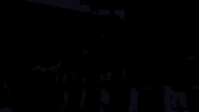 a man wearing a mask is spraying something in the dark