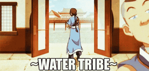 a man and a woman are standing in front of a door that says water tribe on it .