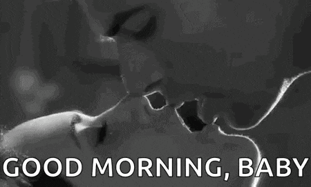 a black and white photo of a man and woman kissing with the words `` good morning , baby '' .