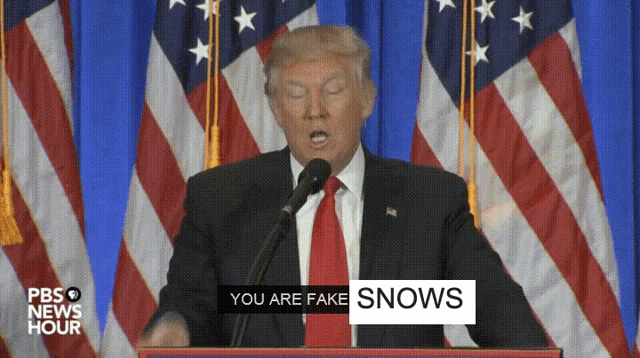 donald trump is giving a speech at a podium with a sign that says you are fake snows